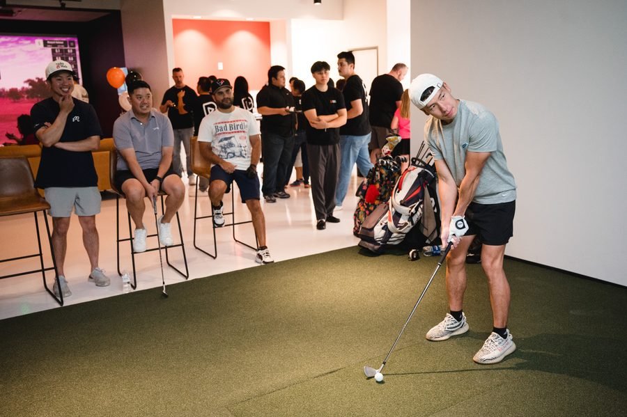 A putting contest during a team event at Birdie Central, colleagues watching
